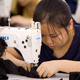 Image for article titled Exhausted Sweatshop Worker Just Has To Laugh After Sewing Fingers Together